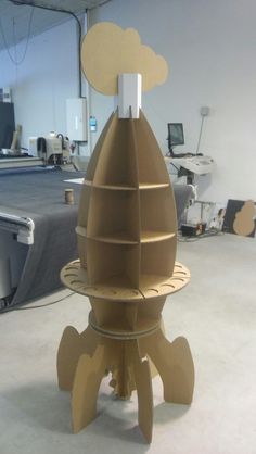 a cardboard rocket ship sitting on top of a table