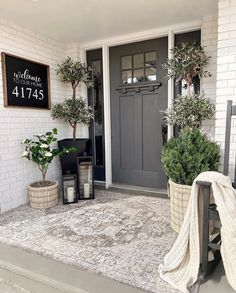 the front porch is decorated with potted plants