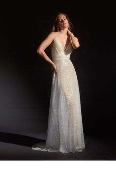 a woman in a white dress posing for the camera