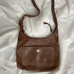 Barely Used Caramel Brown Leather Coach Crossbody Messenger Bag. One Outer [Pocket With Snap Closure; Three Inner Pockets, One Has A Zipper Closure. The Long Shoulder Strap Is Adjustable With Silver Tone Buckle. Strap Measures Approximately 38" Inches Long By 1.75" Wide. The Purse Itself Measures 13" Inches Side By 9.75" Inches High. Classic Dark Tan Crossbody Shoulder Bag, Everyday Brown Hobo Bag With Cell Phone Pocket, Brown Everyday Hobo Bag With Cell Phone Pocket, Cognac Leather Bag With Cell Phone Pocket, Leather Cognac Bag With Cell Phone Pocket, Classic Camel Crossbody Shoulder Bag, Classic Brown Crossbody Hobo Bag, Brown Crossbody Bag With Pockets, Elegant Leather Shoulder Bag With Pockets