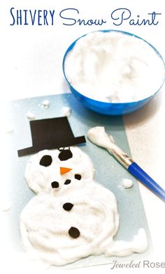 there is a snowman made out of icing next to a bowl of whipped cream