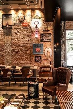 a living room filled with lots of furniture next to a wall covered in pictures and clocks