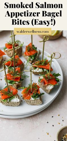 Smoked salmon appetizer bagel bites with arugula and dill on a white plate. Smoked Salmon Bagel Bites, Smoked Salmon Recipes Appetizers, Bagel Bites Recipe, Smoked Salmon Platter, Salmon Appetizer Recipes, Salmon Platter, Smoked Salmon Appetizer, Salmon Appetizer