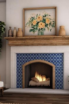 a fire place with a painting on the wall above it and a vase filled with flowers