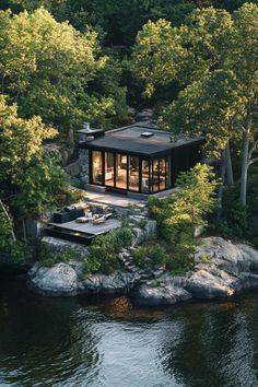 an aerial view of a house on the water