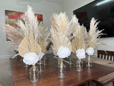 three vases with flowers are sitting on a table