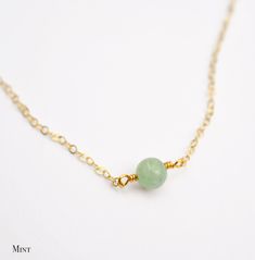 Jade is said to bless whatever it touches! It is lucky stone believed to create harmony within the mind, body, and spirit, while providing protection from harm. It is also said to attract money, love, and friendship. This necklace is handcrafted with a natural Jade stone. The stone is available in several colors including dark olive, light kelly green, nearly white green, and pea green. Choose to have this necklace made in sterling silver or 14kt gold filled. The stone size is 6mm (.25 inches). Dainty Jade Necklace, Jade Jewelry Necklace, Natural Gemstone Necklace, Lucky Stone, Love And Friendship, Mind Body And Spirit, Necklace Green, Jade Necklace, Attract Money