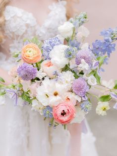 a bride holding a bouquet of flowers in her hands