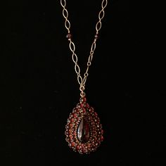 Elevate your style with the mesmerizing allure of Bohemian garnets! Renowned for their deep, wine-red hue and exceptional brilliance, these garnets were highly favored during the Victorian era, symbolizing passion and devotion. Very rare necklace made with Bohemian garnets in the Victorian Era Set on an 18" goldfill chain w/ secure lobster clasp, accented with 6 garnet beads Bohemian garnet center gemstone measures approx. 14x7mm, surrounded by thirty-eight garnets, ranging in size from 2mm-2.5m Elegant Oval Garnet Necklace, Elegant Pear-shaped Ruby Jewelry, Luxury Garnet Pendant Necklace, Elegant Drop Garnet Jewelry, Formal Burgundy Gemstone Jewelry, Antique Garnet Pendant Necklace, Victorian Garnet Jewelry Gift, Fine Jewelry Garnet Pendant, Formal Garnet Fine Jewelry Necklace