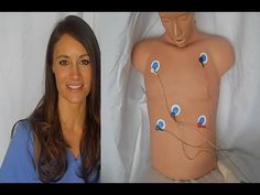 a woman standing next to a mannequin with blue eyes on it's chest