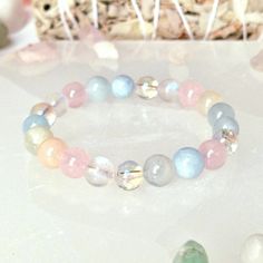 "This beautiful & powerful healing crystal bracelet is made with natural crystal beads of Rose Quartz, Aquamarine, Aura Quartz, Morganite and Moonstone.  The Abundance healing crystal bracelet combines key high vibrational crystals specifically designed to heal your heart and help you to manifest abundance, it will support you in letting go of the past and embracing your true self, you will feel genuine love for yourself and love for life, you will regain the energy to take on new adventures and Hand-strung Rose Quartz Crystal Bracelet For Healing, Spiritual Rose Quartz Crystal Bracelet For Healing, Rose Quartz Gemstone Beads Bracelet For Meditation, Spiritual Rose Quartz Crystal Bracelet With 8mm Beads, Spiritual Rose Quartz Bracelet With 8mm Beads, Spiritual Rose Quartz Beaded Crystal Bracelet, Spiritual Beaded Rose Quartz Crystal Bracelet, Heal Your Heart, Girly Bracelets