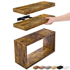 a hand holding a wooden shelf with different colors