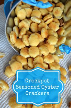 crockpot seasoned oyster crackers in a bucket on a table with blue ribbon