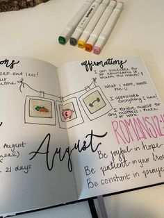 an open notebook with writing on it next to some markers and crayon pens