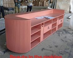 a large pink shelf sitting inside of a warehouse next to other people in the background