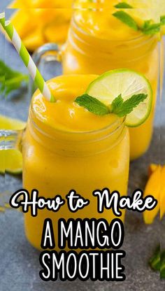 two mason jars filled with mango smoothie and garnished with fresh mint leaves