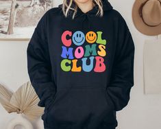 Cool Mom Club Hoodie, Cool Mom Club Hoodie, Cute Graphic Hoodie For Girls, Mothers Day Gift, Gift For Mother, Mothers  Day Hooded Sweatshirt 🌾Welcome to "Boutique Grace Sweatshirt & Hoodie Store"... I will be presenting sweatshirts and hoodies, which are indispensable for your autumn and winter days, with special and different designs in my store.🌾 🌾Product Features ✔️Gildan® Heavy Blend™ Unisex Hoodie  ✔️50% Cotton / 50% Polyester ✔️Preshrunk fleece knit ✔️Classic Fit ✔️ Air jet yarns = soft Fun Hooded Hoodie With Letter Print, Winter Fun Hoodie With Letter Print, Fun Letter Print Hoodie For Winter, Fun Winter Hoodie With Letter Print, Black Long Sleeve Fun Hoodie, Fun Hoodie With Letter Print, Hoodie Store, Hoodie Cute, Cool Mom