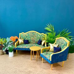 a living room filled with furniture and potted plants on top of carpeted floor