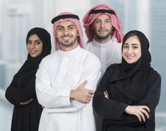 three men and two women are standing together