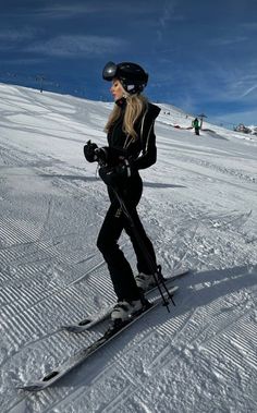 a woman on skis is standing in the snow