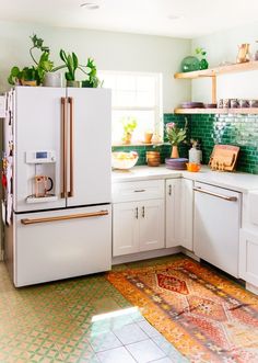 a white refrigerator freezer sitting inside of a kitchen next to a counter top oven