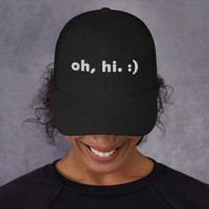 Need a trendy, modern hat for a birthday gift, Father's Day, or another fun occasion? Grab this minimalist hat from our shop, for any person and any age! ~~ THE "OH HI" DAD HAT~~ Oh, hi! A simple, silly hat that serves as a great icebreaker in public. This cap is sure to get some smiles as you rock it in public, why not pick one up? This hat Means Minimal. ~~ WELCOME TO MEANS MINIMAL. ~~ Welcome, thanks for much for visiting! Our products are here to help you embody a minimalist, flowing, and simple lifestyle. We keep your fits modern and your faces happy.  ~~ MORE DETAILS ~~ * 100% chino cotton twill * Unstructured, 6-panel, low-profile * 6 embroidered eyelets * 3 ⅛" (7.6 cm) crown * Adjustable strap with antique buckle and curved visor * Sourced from Vietnam or Bangladesh Oh Hi Modern Ha Casual Letter Print Hat For Birthday, Casual Snapback Hat For Birthday, Trendy Letter Print Hat For Gift, Casual Black Hat For Birthday, Black Dad Hat With Curved Brim As Gift, Funny Hats With Letter Print As Gift, Funny Baseball Cap For Gift, Funny Letter Print Hats For Gift, Funny Letter Print Hats As Gifts