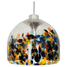 a multicolored glass light hanging from a ceiling fixture