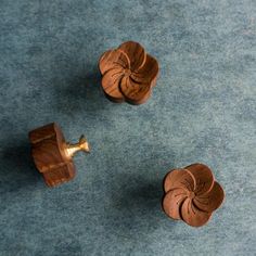 two small wooden knobs on a blue carpet