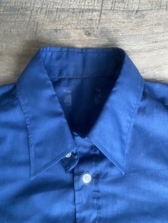 "This deep blue, genuine 1970s vintage, short sleeve, butterfly collared shirt is in excellent vintage condition. SIZE: Pit to Pit: 25\" Collar to hem: 31\" Sleeves: 11\" The tag does not have a size. Check the measurements. I would say it fits like a roomy XL The male mannequin would be 5'10\" 170 lbs. ITEM 125" Classic Blue Shirt For Summer, Solid Vintage Summer Shirt, Classic Cotton Formal Short Sleeve Shirt, Vintage Fitted Camp Shirt With Short Sleeves, Vintage Fitted Short Sleeve Camp Shirt, Blue Camp Shirt With Spread Collar And Button Closure, Fitted Vintage Short Sleeve Camp Shirt, Blue Fitted Short Sleeve Camp Shirt, Vintage Summer Shirt