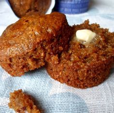 two muffins are sitting on a blue cloth