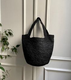 - Piece made by hand in our Malagasy workshop - Woven by: Ranja - Shoulder basket - Raffia exterior in two different weaves - Raffia interior with one pocket - Handle length: 22 cm - Non-adjustable handle - Bag weight: 300 g - Dimensions: 39cm * 29cm * 17cm - Color: dark tea or black ▫️ NATURAL MATERIAL ▫️ HANDMADE ▫️ ECO-FRIENDLY Natural Bucket Bag With Intrecciato Weave, Rectangular Natural Bucket Bag With Intrecciato Weave, Basket-shaped Bucket Bag In Woven Leather And Jute, Rectangular Intrecciato Weave Bucket Bag For Vacation, Basket-shaped Straw Bag With Intrecciato Weave, Straw Bucket Bag With Intrecciato Weave, Rectangular Bucket Bag With Intrecciato Weave For Vacation, Beach Straw Bag With Intrecciato Weave In Natural Color, Vacation Bucket Bag Tote With Intrecciato Weave