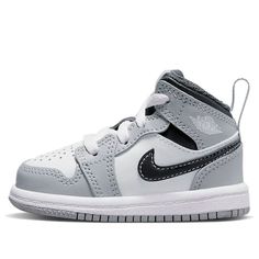 the nike air jordan 1 mid is available in white, black and grey colorway