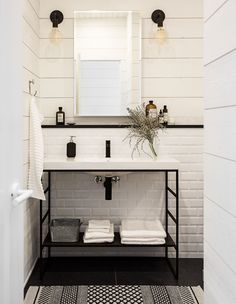 a white bathroom with black and white accents