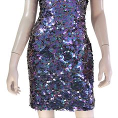 "This 80s-era trophy dress features a fun mermaid scale pattern of iridescent purple sequins and gold beads, a halter neck bodice with open back, and mini length skirt. Perfect for holidays, special occasions, or any time you need to glam it up a bit. Dress is unlined and zips up the back. Best fits size xs or small (please check measurements below). Accessories not included. Payment plans available. Approximate Flat Measurements: Multiply times 2 for bust, waist, and hip measurements. For best Fitted Sequin Dress With Mermaid Hem For Prom, Fitted Sequin Mermaid Hem Dress For Prom, Embellished Fitted Disco Mini Dress, Embellished Fitted Mini Dress For Disco, Fitted Embellished Mini Dress For Disco, Glamorous Purple Sequin Mini Dress, Fitted Purple Mini Dress With Sequins, Glamorous Purple Mini Dress With Sequins, Purple Fitted Mini Dress With Sequins