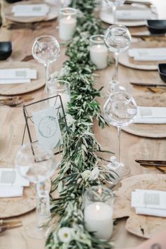 the table is set with candles, plates and napkins