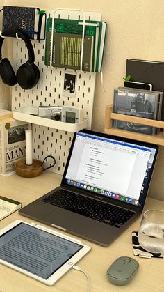 an open laptop computer sitting on top of a wooden desk