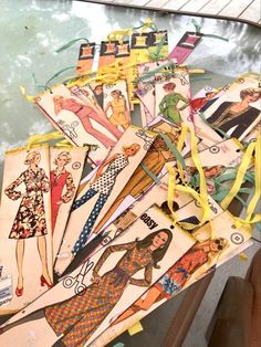 an assortment of paper dolls are sitting on a table