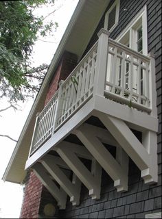 a white balcony on the side of a house