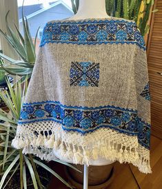 These beautiful ponchos are handmade by indigenous artisans in Hueyapan Puebla. Every design is unique, hand-embroidered according to the traditions of the community. Measuring approximately 34" wide by 26'' long, one size should fit all adults. All ponchos can be worn 2 ways: Flat across the front or point down, for a longer, more flowing look. Mexican Gifts, Mexican Outfit, Mexican Jewelry, Scarf Jewelry, 2 Way, Simply Beautiful, The Community, Ponchos, Handmade Art