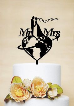 a wedding cake topper that says mr and mrs with the earth in the middle