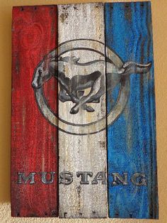 a wooden sign with the word mustang painted on it and an image of a horse