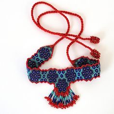 Vintage fringe choker necklace, in classic boho, southwestern style vibe. Adjustable with tie back closure. In very good pre-owned condition. Red, royal and turquoise blue, hematite silver, and yellow/gold accents. Hundreds of woven glass seed beads, finished with a red cord tie. Red is richer in person, and not orange. Bead cluster ball ends for a great look! Beaded band portion is approximately 9 1/4" x 1" wide. Fringed center portion hangs down approximately 2 3/8" from top of band. Cords are 10" long, excluding beaded ends. Necklace length is very adjustable. Beautiful colors and pattern--classic beaded fringe choker! Will be boxed. NOTE: Orders are sent via USPS Ground Advantage. For faster shipping, choose Priority Mail at checkout. Etsy's estimated delivery dates are not guaranteed. Seed Bead Choker, Crystal Falls, Vintage Fringe, Cord Ties, Bead Choker, Southwestern Style, Beaded Fringe, Beaded Choker, Necklace Length