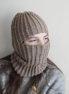 Embrace the winter chill with our exquisite handmade, knitted unisex balaclava, thoughtfully crafted from lightweight and warm alpaca wool yarn. Designed to fit both teens and adults comfortably, this balaclava is the epitome of style and functionality. Its luxurious texture, delicately adorned with a mesmerizing cable pattern, adds a touch of elegance to your winter wardrobe. Indulge in the unparalleled softness and insulating properties of alpaca wool, keeping you cozy and snug during the coldest of days. Despite its incredible warmth, the lightweight nature of the balaclava ensures breathability, preventing you from feeling stuffy or uncomfortable. Whether you're conquering snowy peaks, taking a serene winter walk, or simply relishing the crisp air, our balaclava promises to be your tru Winter Soft Knit Fitted Knitting Pattern, Fitted Soft Knit Winter Knitting Pattern, Winter Alpaca Knitting Pattern, Brown Knitted Pattern For Winter, Warm Knit Balaclava For Cold Weather, Fitted Knitted Balaclava For Cold Weather, Casual Fitted Knitted Balaclava, Wool Knitted Balaclava For Winter, One-size Knitted Balaclava For Outdoor Use