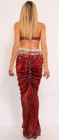 This show-stopping two-piece set showcases beautiful embellishments such as rhinestones, beads, and embroidery in a majestic shade of Burgundy. This two-piece costume features a dina halter bra, and built-in shorts with embellished dazzling crystals. Length is from the top of the skirt. Glamorous Fitted Embellished Sets, Glamorous Red Sequined Sets, Fitted Evening Sets With Rhinestones, Red Hand Embellished Traditional Drape Sets, Embellished Red Party Sets, Embellished Red Sets For Party, Elegant Fitted Sets With Rhinestones, Elegant Fitted Set With Rhinestones, Evening Sets Hand Embellished And Fitted