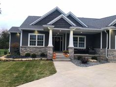 a gray house with white columns and windows