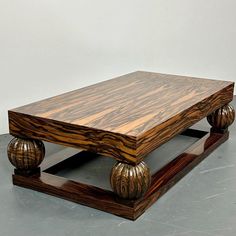 a wooden table with two metal balls on the bottom and one is made out of wood