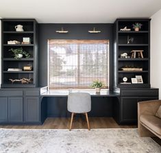 a living room with built in bookshelves and a couch next to the window