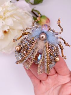 a person is holding a brooch in their hand