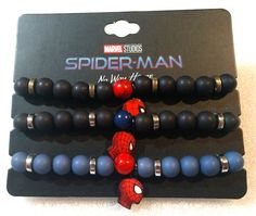 three bracelets with spiderman beads on top of each other in black, blue and red