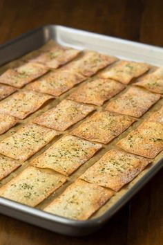 a pan filled with crackers sitting on top of a wooden table